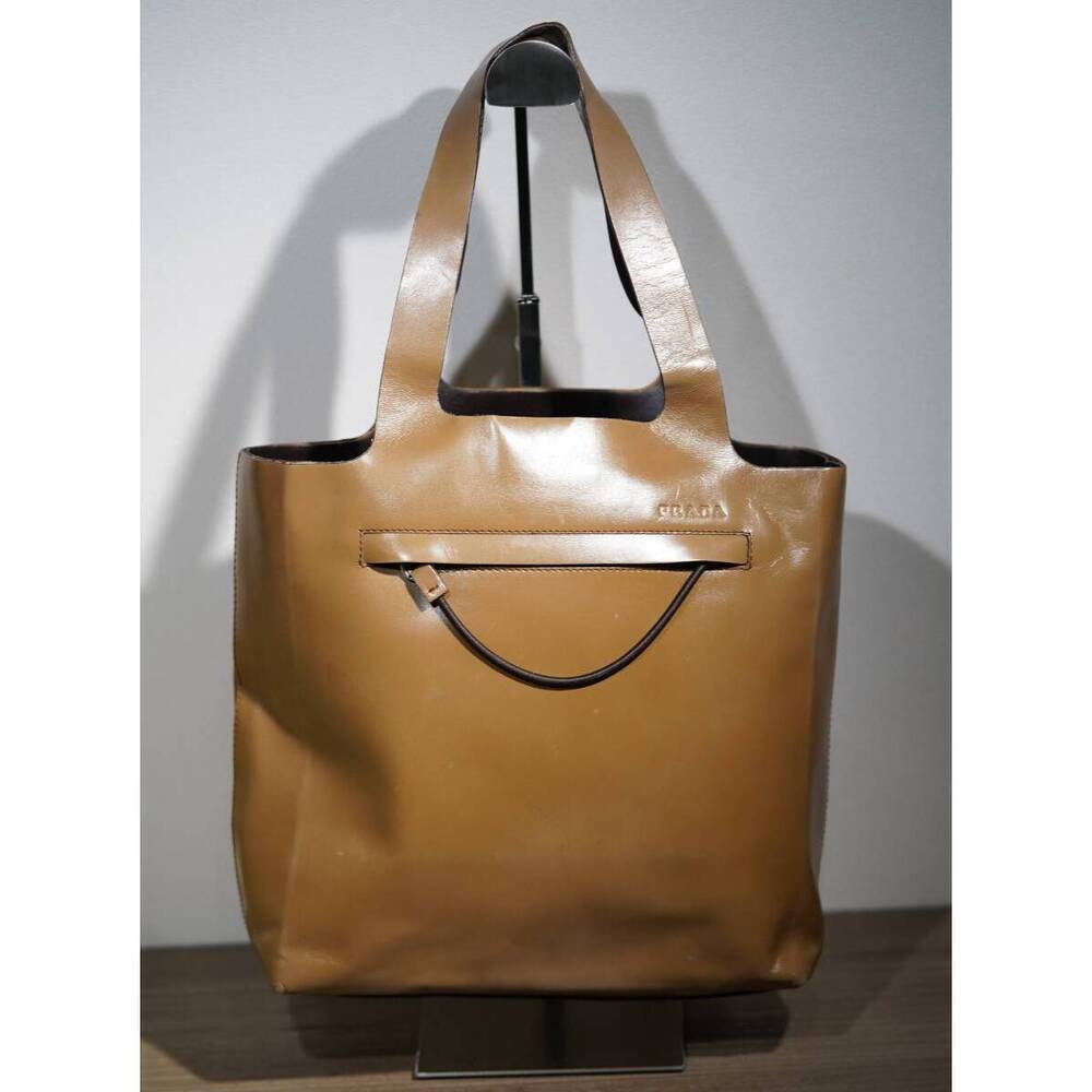 Prada tote bag prominent zippered pocket U shaped metallic